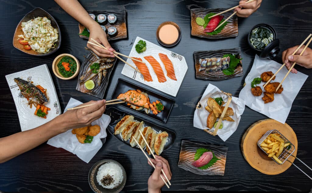 Top view of people eating Japanese food
